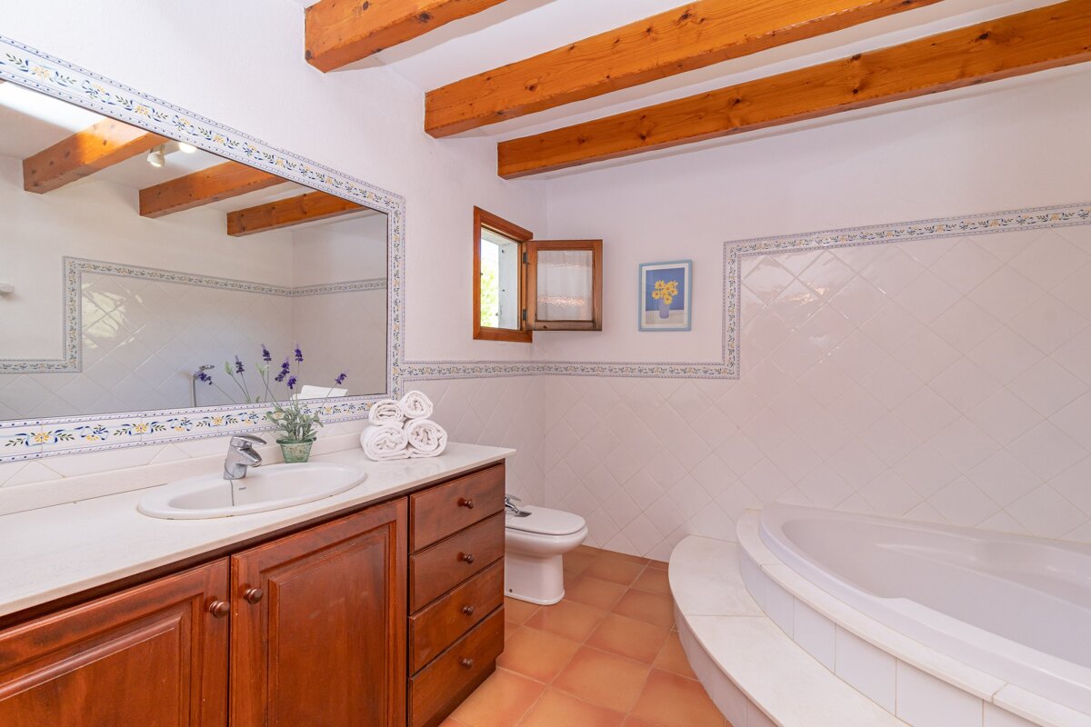 A bathroom with a sink toilet and bathtub