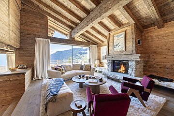A living room with a couch and chairs and a fireplace