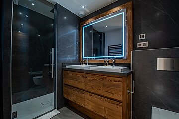 A bathroom with two sinks and a large mirror