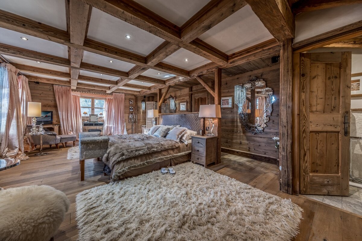 A bedroom with a large bed and a rug