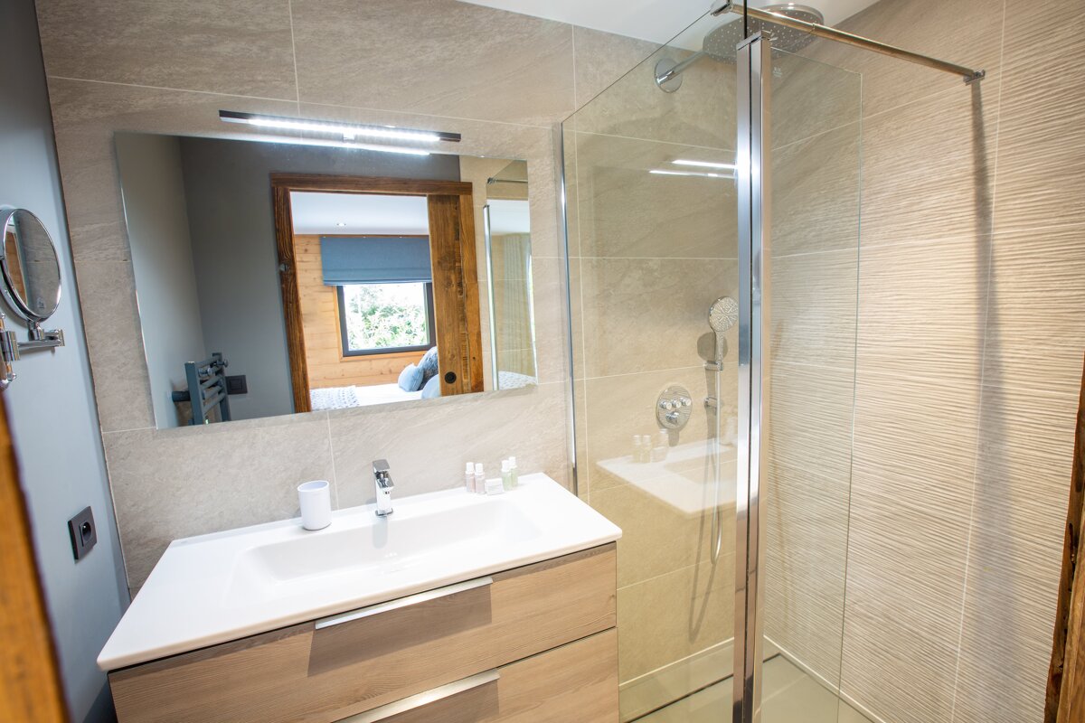 A bathroom with a sink and a walk in shower