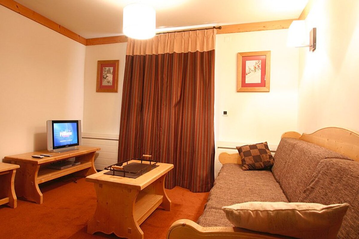 A living room with a couch and a flat screen tv