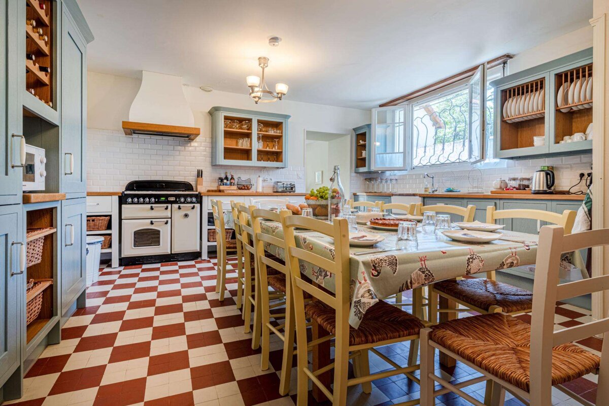A kitchen with a table and chairs and a checkered floor