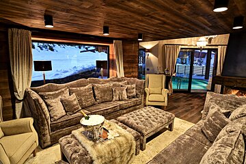 A living room with a large couch and chairs