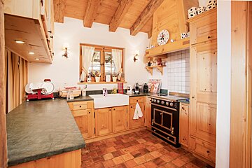 A kitchen with wooden cabinets and a black stove