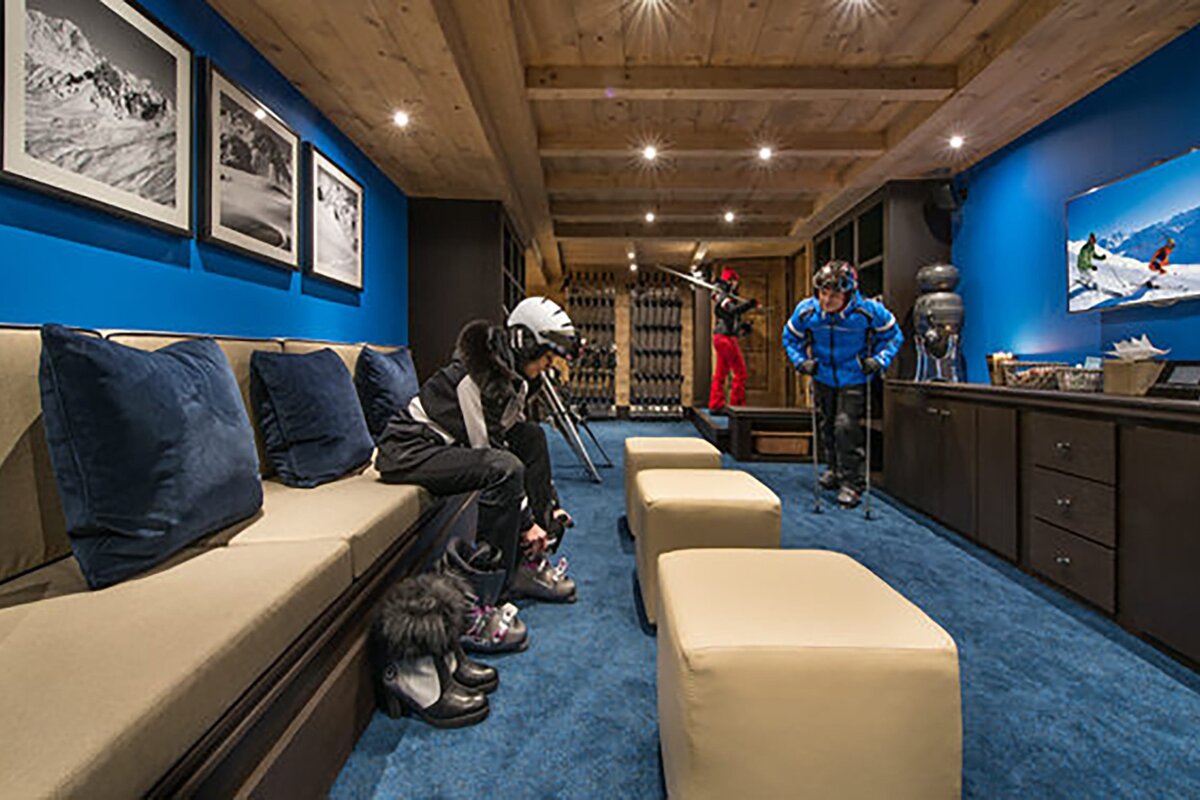 A man in a blue jacket is standing next to a woman in a ski suit