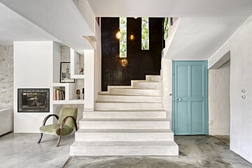A staircase with white steps and a blue door