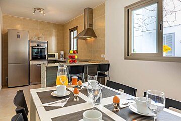 A kitchen with a stainless steel refrigerator and a dishwasher