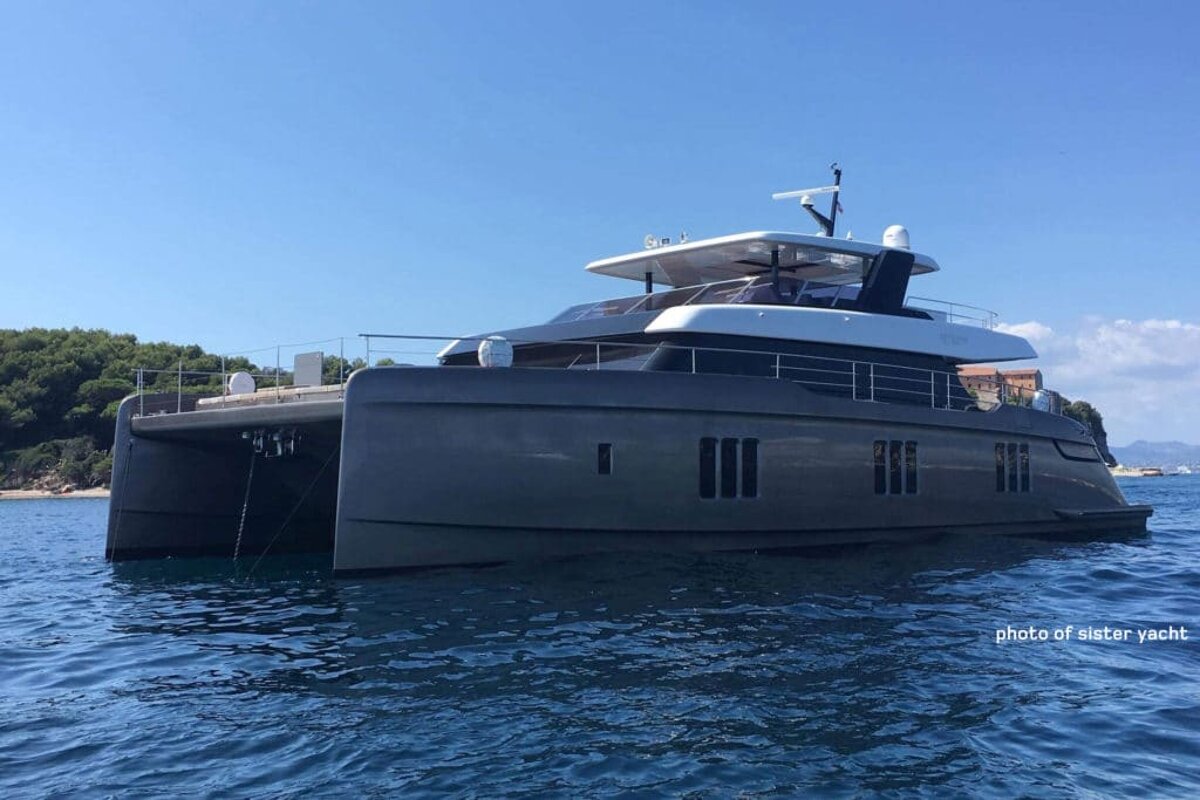 A large gray and white yacht is floating in the ocean