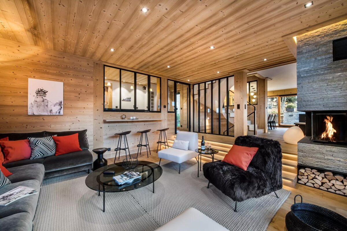 A living room with a couch and chairs and a fireplace