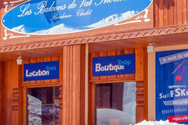 A store front with a blue sign that says location