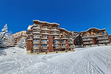 A snowy building with a blue sky in the background