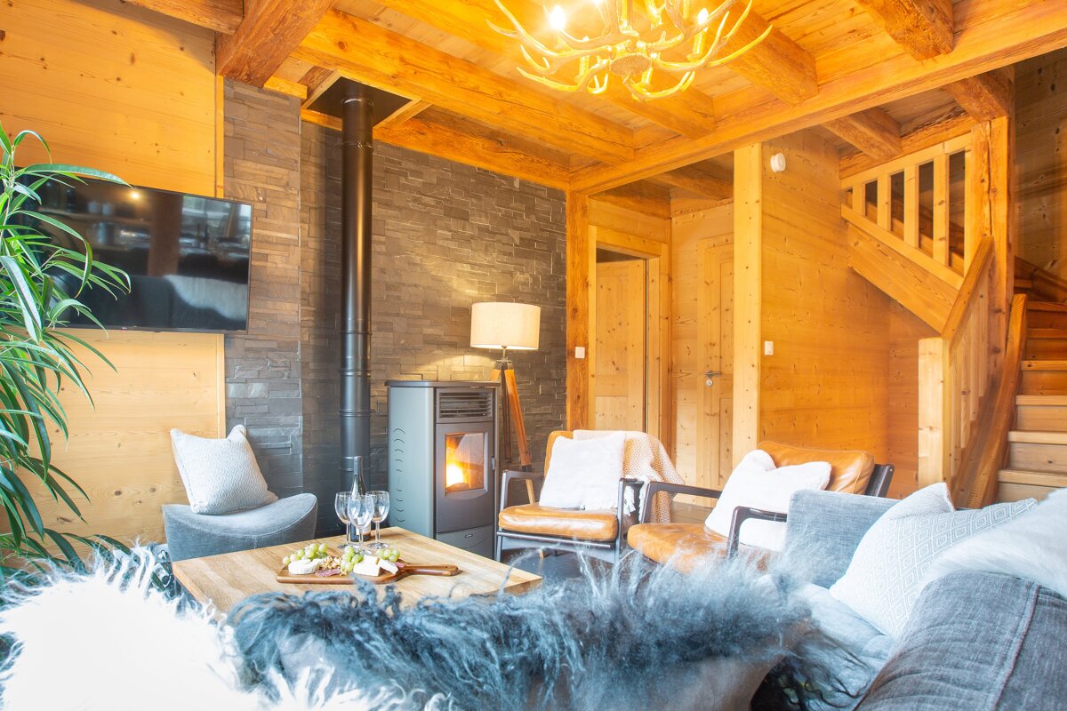 A living room with a wood stove and a flat screen tv