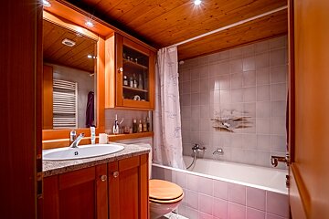 A bathroom with a sink toilet and bathtub