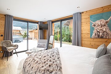 A bedroom with a painting of a yak on the wall