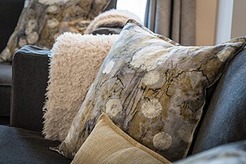 A couch with pillows and a blanket on it