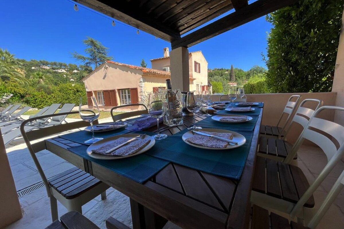 A table with plates and wine glasses on it