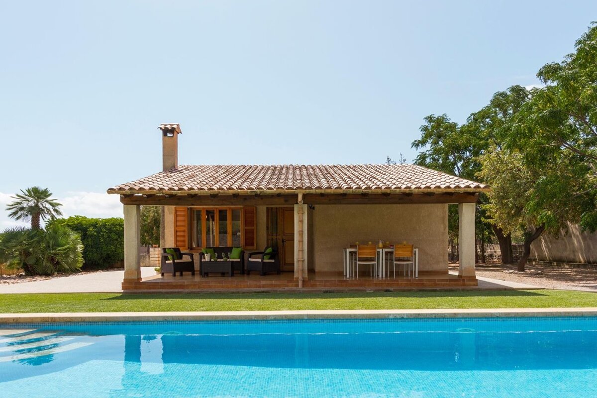 A house with a swimming pool in front of it