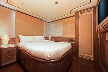 A small bedroom with a bed and a nightstand