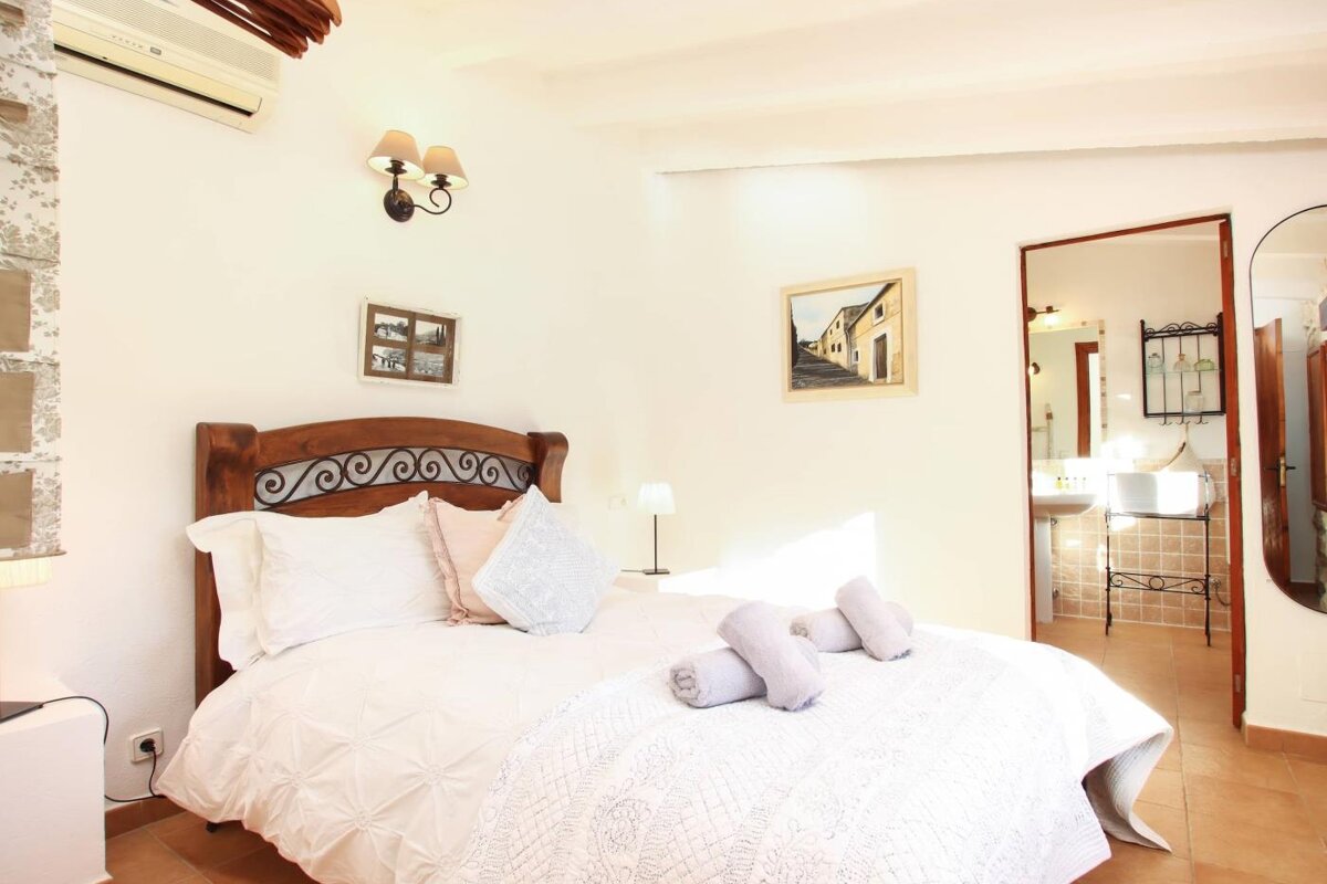 A bedroom with a bed and a picture on the wall