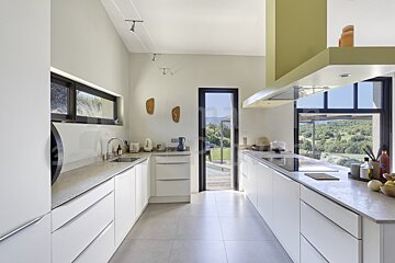 A kitchen with white cabinets and granite counter tops