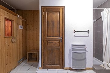 A bathroom with a wooden door and a towel rack