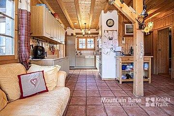 A living room with a couch and a clock that says mountain base