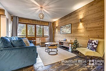 A living room with a blue couch and a yellow chair from mountain base