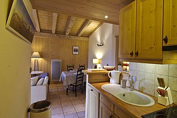 A kitchen with a sink and a picture on the wall