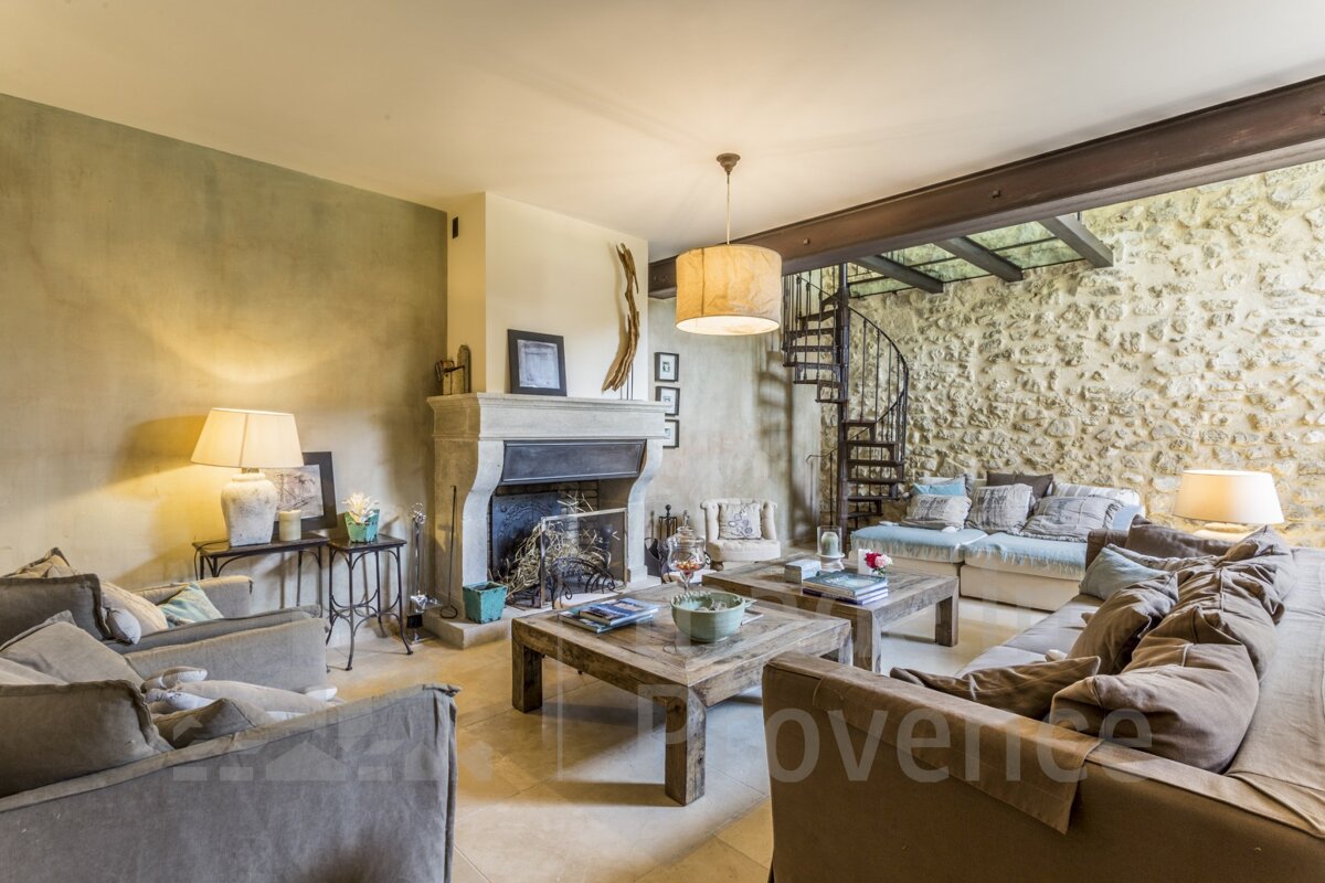 A living room with a fireplace and a spiral staircase that says provence