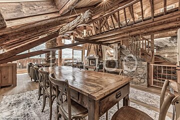 A large wooden table and chairs in a cabin