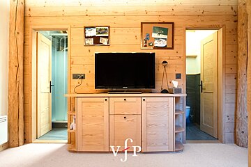 A samsung flat screen tv sits on a wooden entertainment center
