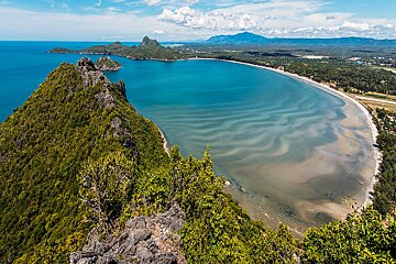 A large body of water surrounded by mountains and trees