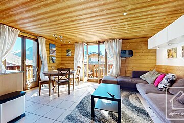 A living room with a couch a table and chairs and a sign that says alpine-pro