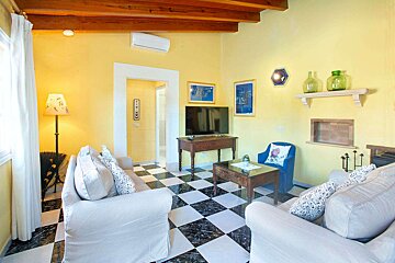 A living room with yellow walls and a checkered floor