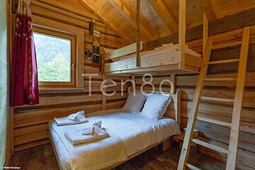 A bedroom with a bunk bed and the word ten8a on the wall