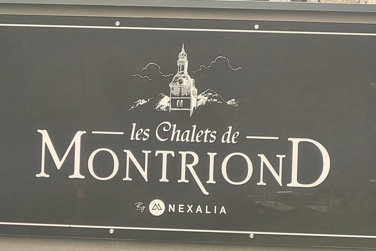 A sign that says les chalets de montriond by nexalia