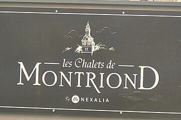 A sign that says les chalets de montriond by nexalia