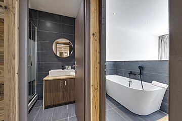 A bathroom with a bathtub and a sink