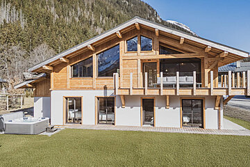 A balcony with a view of mountains and trees