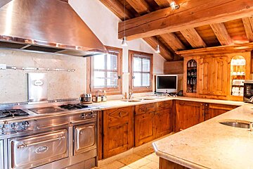 A kitchen with stainless steel appliances and wooden cabinets