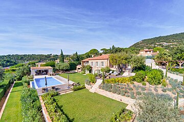 An aerial view of a large house with a swimming pool