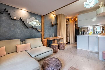 A living room with a couch and two stools