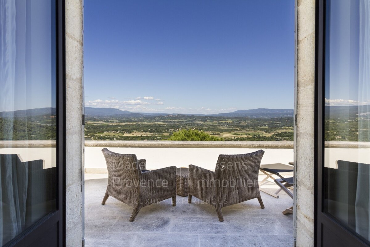 A balcony with two chairs and a table that says made in provence
