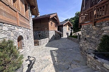 A stone building with a clock on the top of it