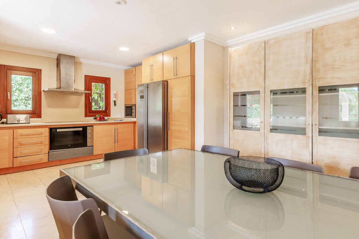 A kitchen with stainless steel appliances and wooden cabinets