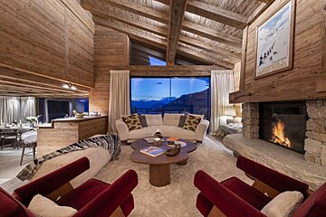 A living room with a couch and chairs and a fireplace