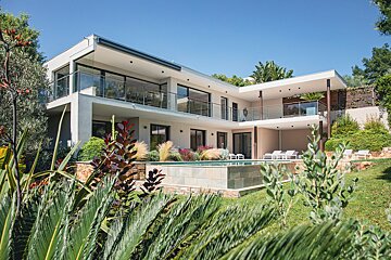 A large white house with a swimming pool in the backyard