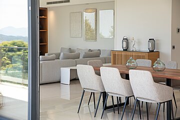 A living room with a dining table and chairs