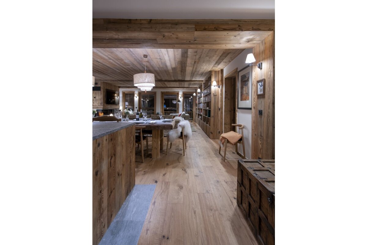 A dog standing in a hallway in a wooden house